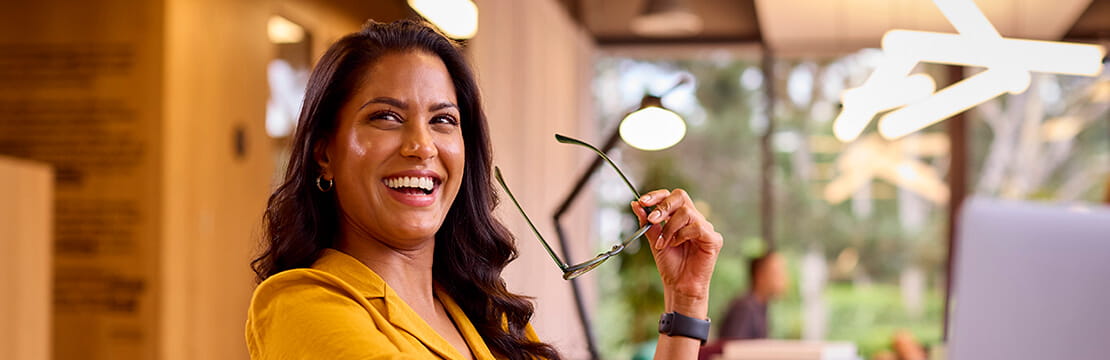 Mature businesswoman with glasses working on laptop